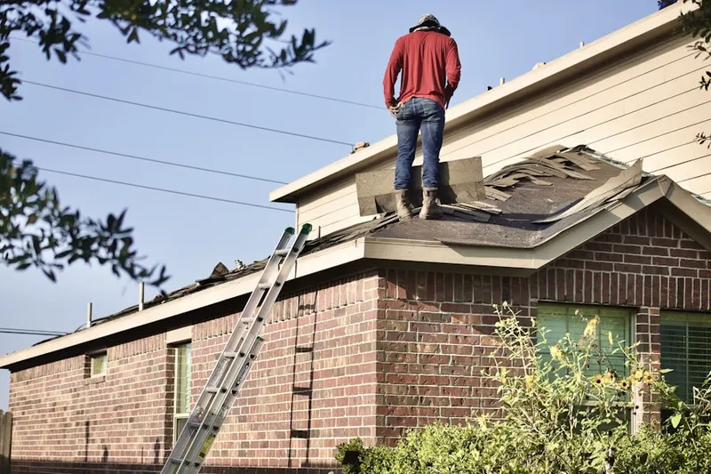 Professional roofer working on a residential roof in North Highland
